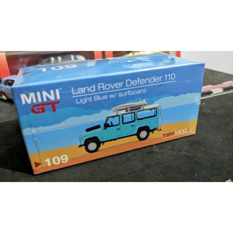 Diecast Mini gt Land rover defender 110 light blue with surfboard no 109