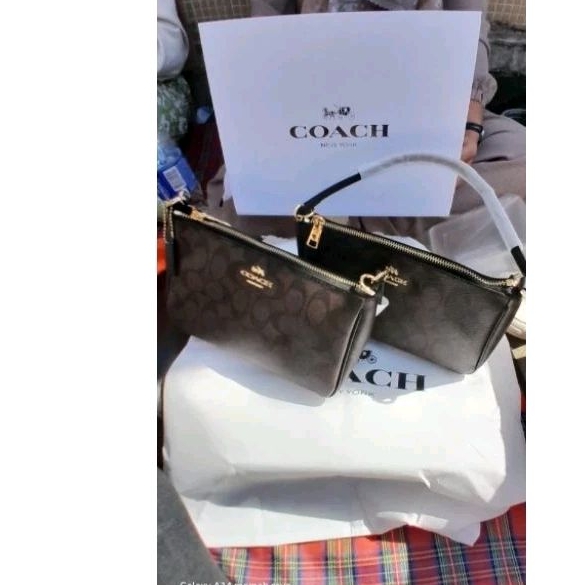 Preloved Tas wanita Coach top handle pouch in signature canvas mahognay
