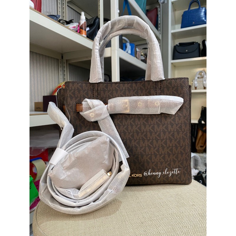 MK emilia satchel brown sign
