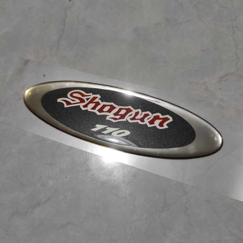 Stiker emblem Panel dada Timbul Suzuki Shogun 110 Kebo rem tromol ori original