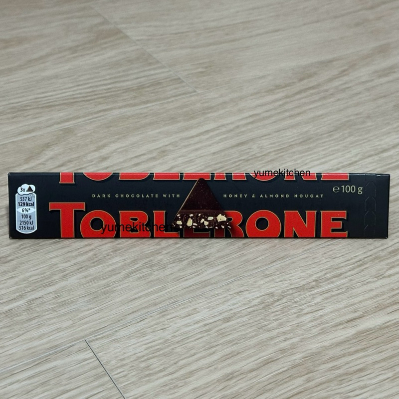 

Preorder Toblerone Dark Chocolate with Honey & Almond Nougat 100 g - Coklat Swiss