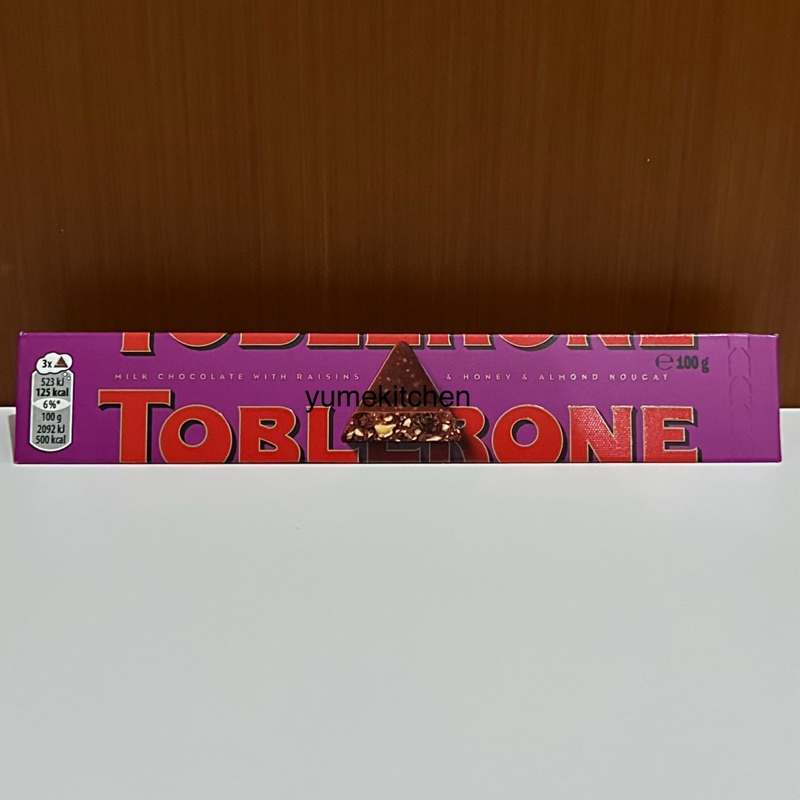 

Toblerone Milk Chocolate with Raisins (Dried Grapes) and Honey & Almond Nougat 100 g - Coklat Swiss