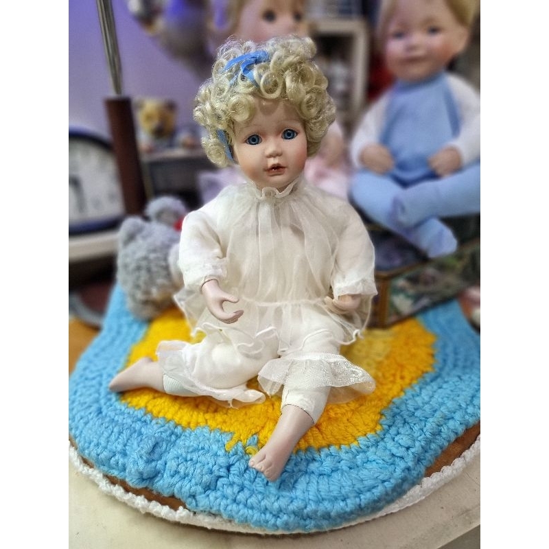 Sitting porcelain doll