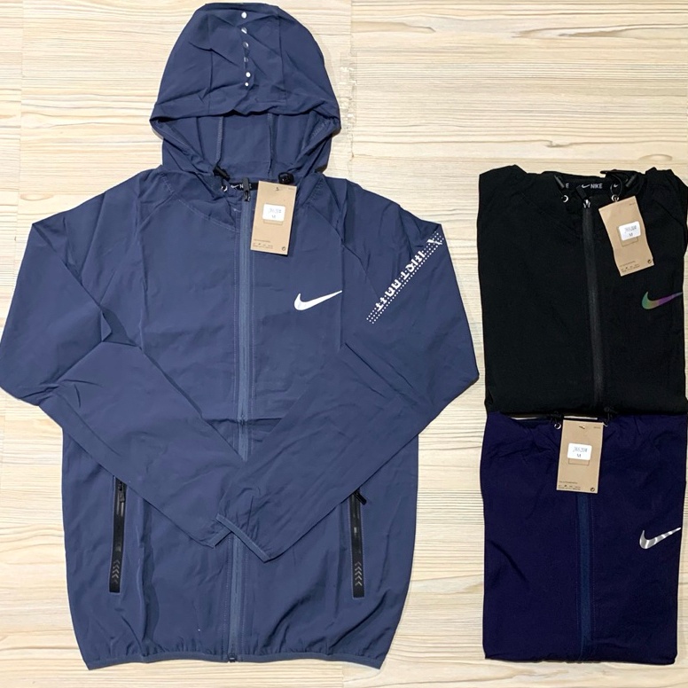 JAKET PARASUT MICRO NIKE TOPI IMPORT PREMIUM HOODIE KUPLUK OLAHRAGA RUNNING MAN PRIA PUTIH ABU HITAM