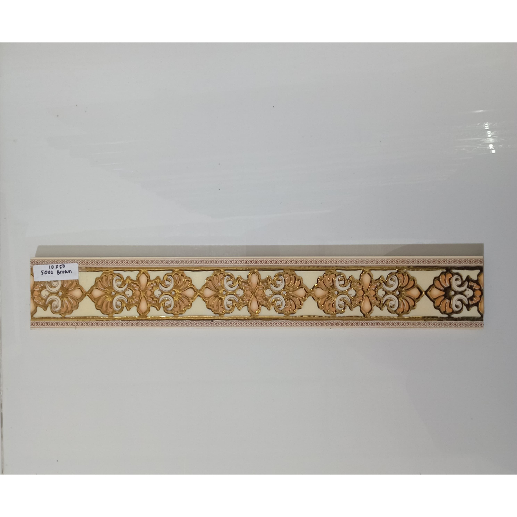 LIST KERAMIK 10 x 50 5002 BROWN/ LIST DINDING MOTIF UKIRAN (GOLD)