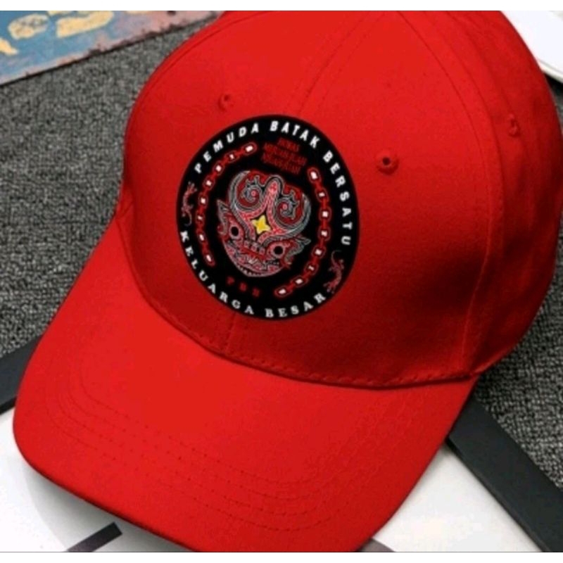 topi rapel logo pemuda batak bersatu