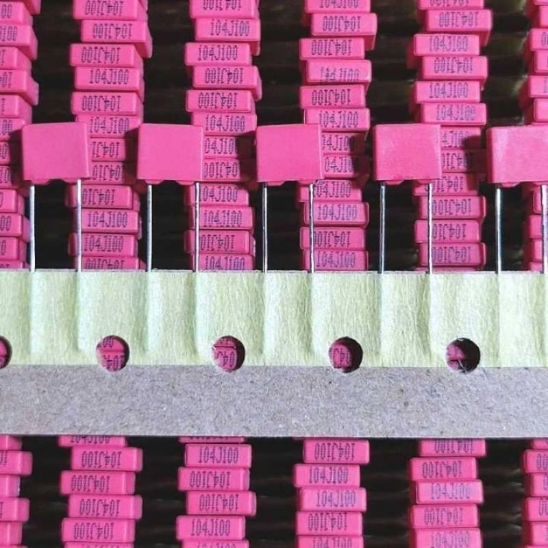 Capacitor mkm 104 100v Merah