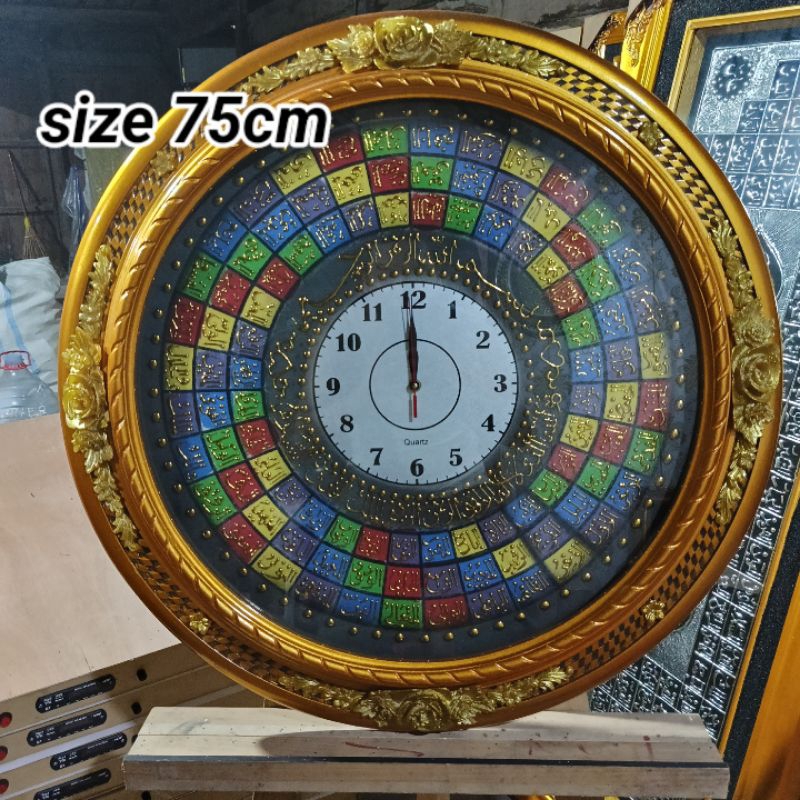 KALIGRAFI ASMA' UL HUSNA JAM BINGKAI UKIR KEMBANG