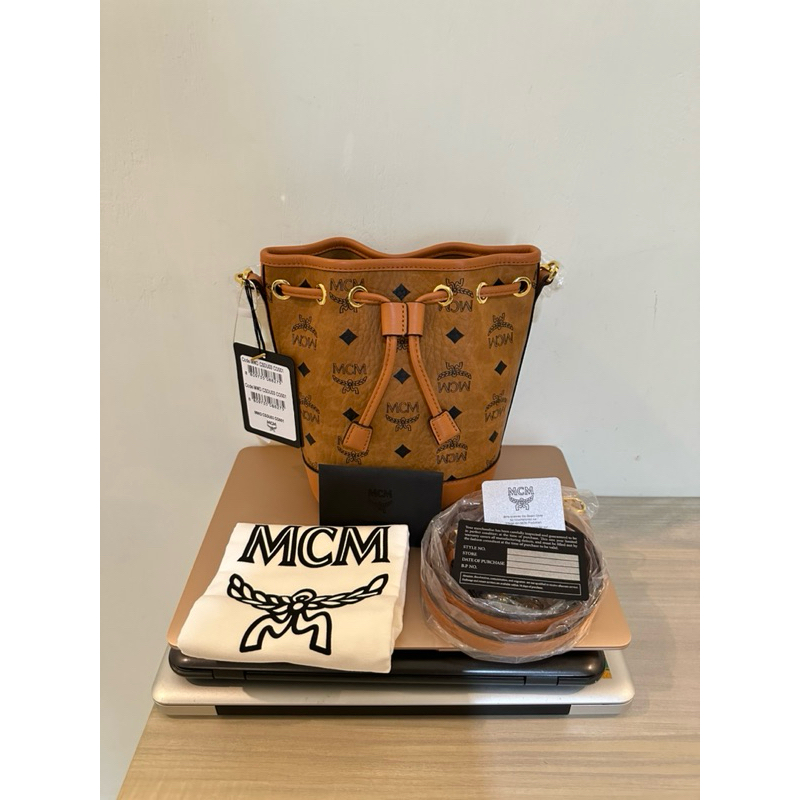 MCM mini dessau drawstring bag in visetos cognac