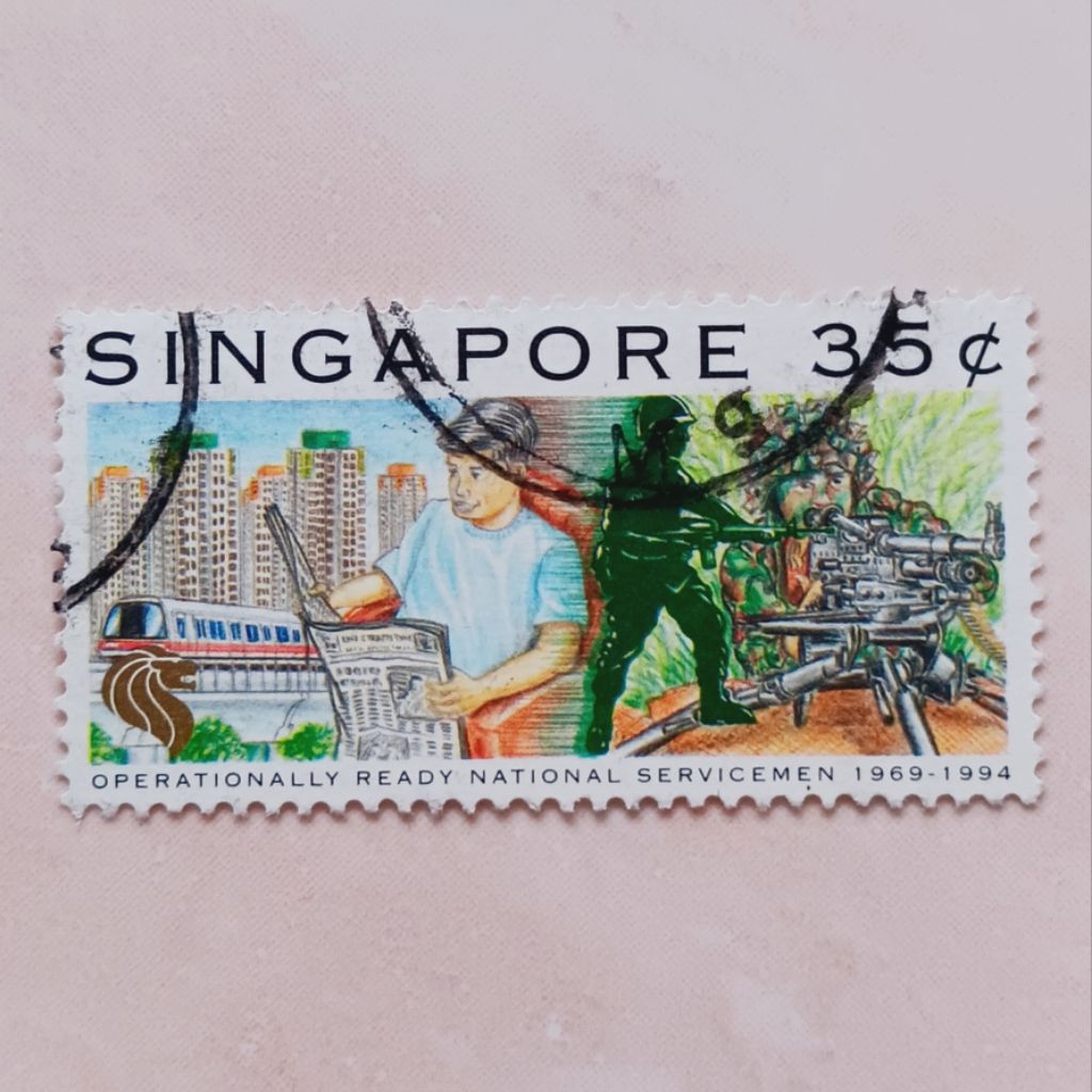 

(AA) Perangko Singapore 1994 25th anniversary of Operationally Ready Natl. Servicemen - Reading newspaper, aiming machine gun 35 cent Used