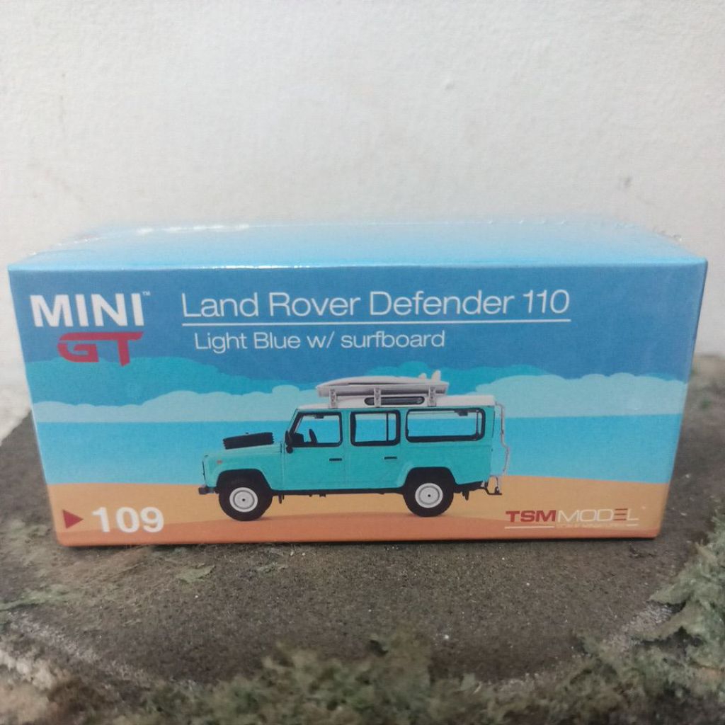 Mini GT//109 Land Rover Defender 110 Light Blue w/ surfboard LHD (Free Protektor)