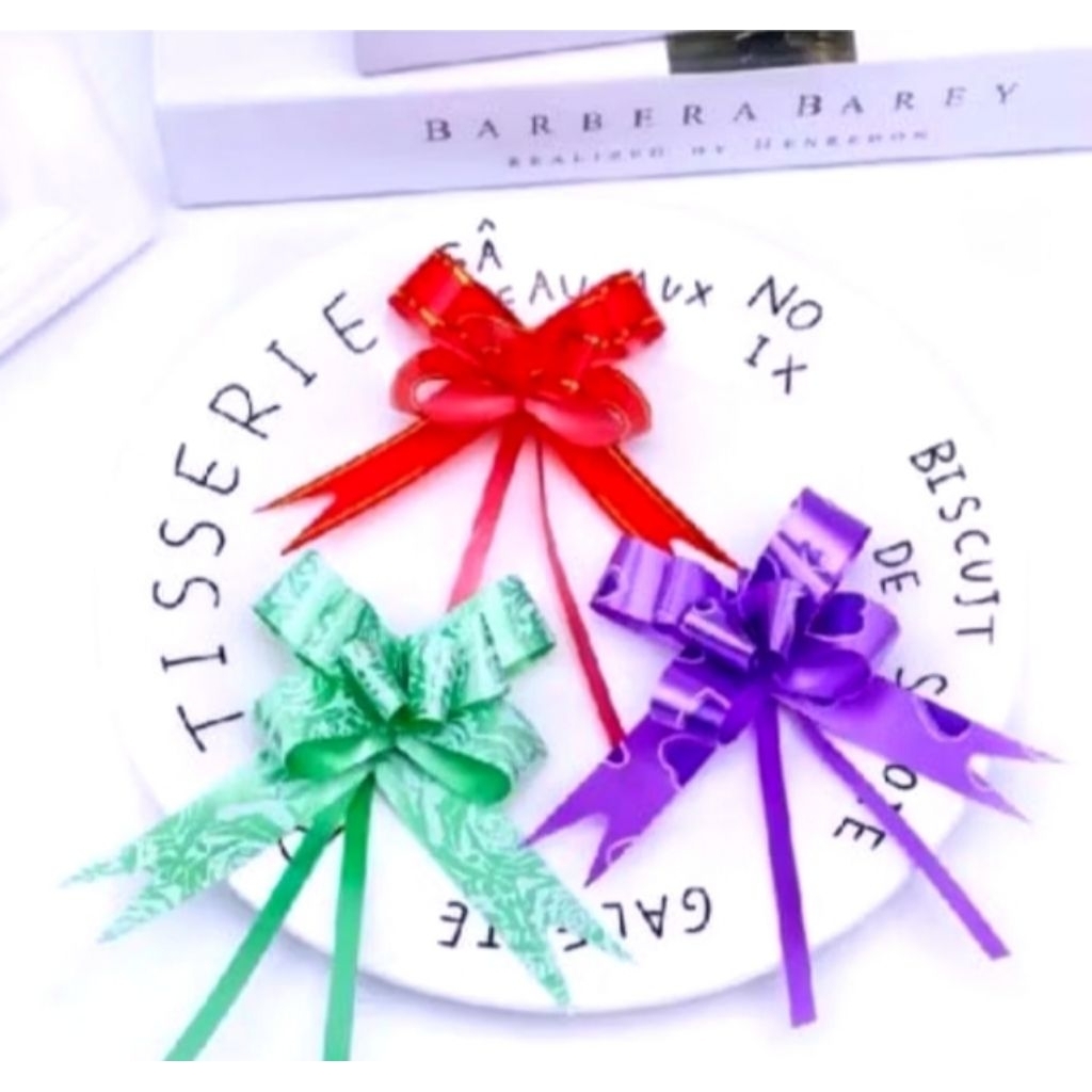 

Pita Tarik Sedang 23mm/ Pita Serut Hiasan Parcel Souvenir Kado Pull Flower