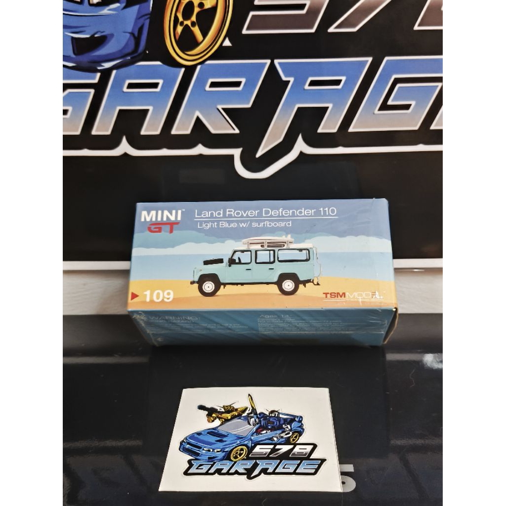 Mini GT Land Rover Defender 110 Light Blue W/ Surfboard Unsealed box