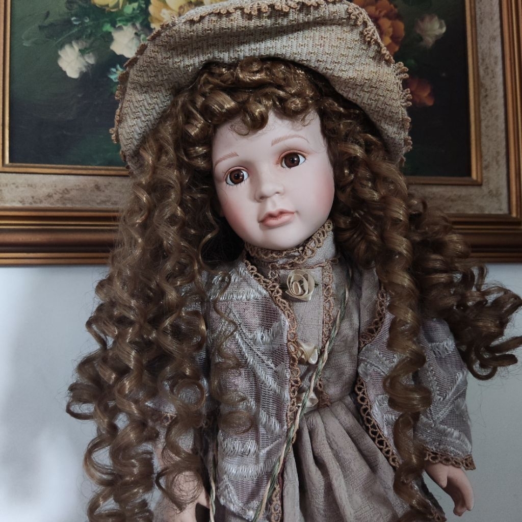 Collectible Elegant Porcelain Doll with Long Curly Hair, Wearing a Victorian-Style Beige Dress, Matc
