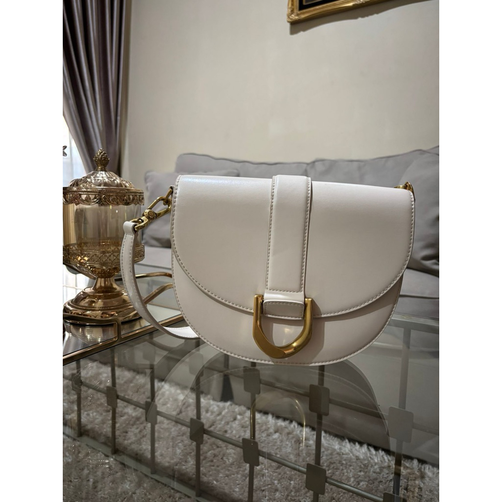 (SECOND HAND) Charles and Keith Gabine Leather Saddle Bag in Ivory
