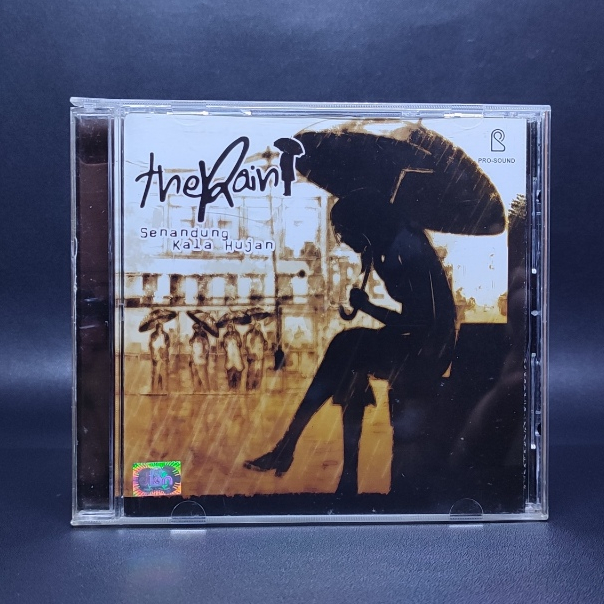 CD THE RAIN - SENANDUNG KALA HUJAN & SERENADE ORIGINAL SEGEL