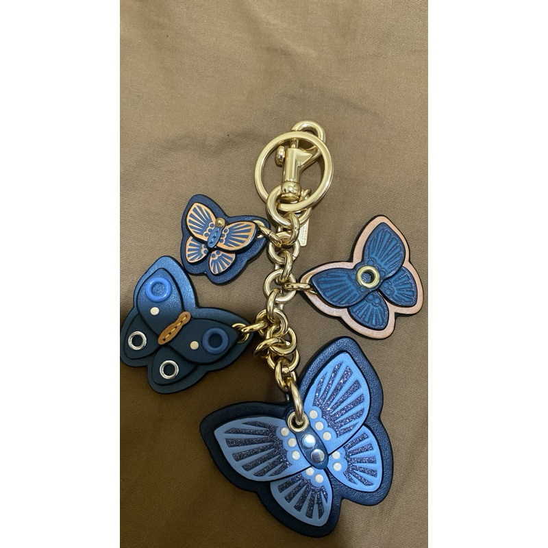 Charm Renteng Coach kupu kupu