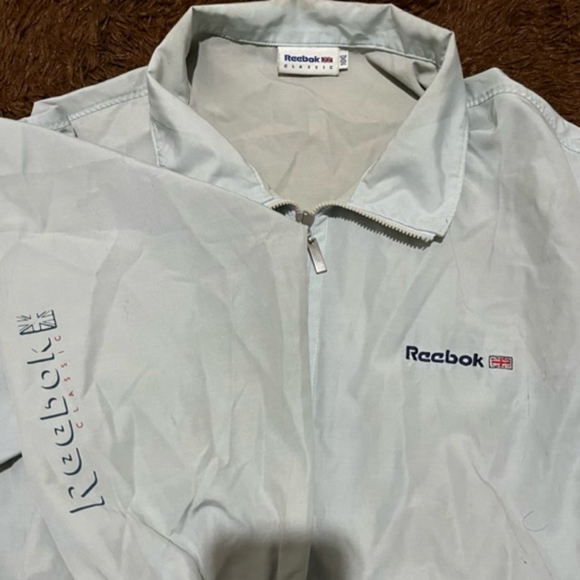 WINDBREAKER REEBOK SPELLOUT