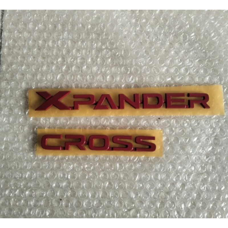 emblem xpander cross merah