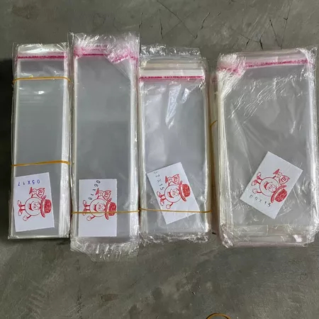 PLASTIK OPP LEM /PLASTIK OPP SENDOK GARPU/PLASTIK UANG TEBAL 0.3MM ISI 100 LEMBAR INV2