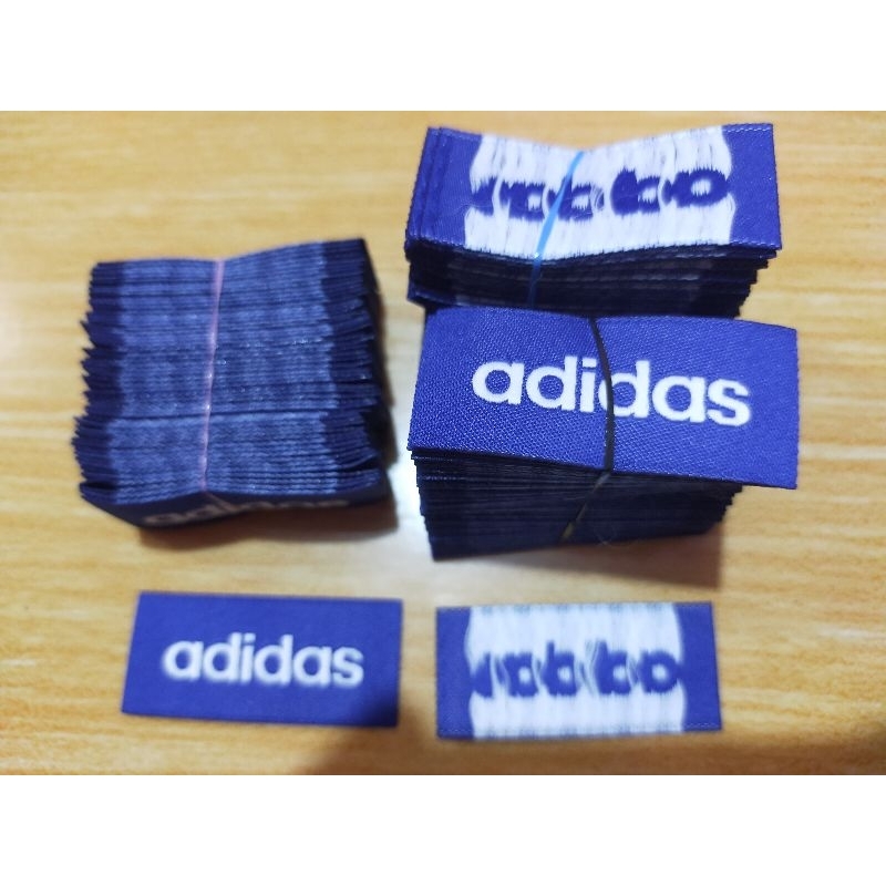 

label merek brand label adid@s uk.(2x4,5)cm harga isi 50 pcs