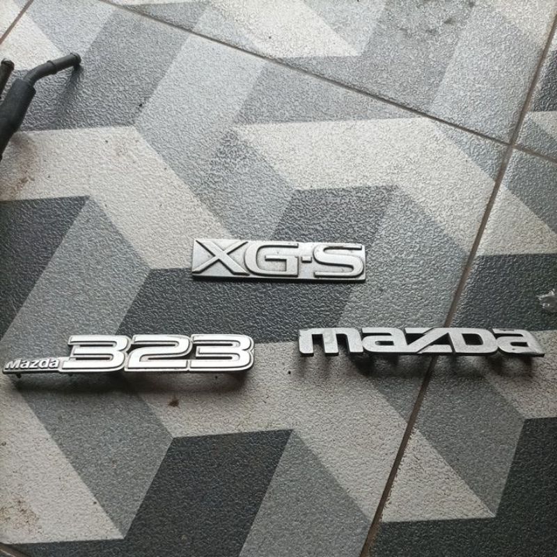 Emblem bagasi set mazda 323 elite / trendy