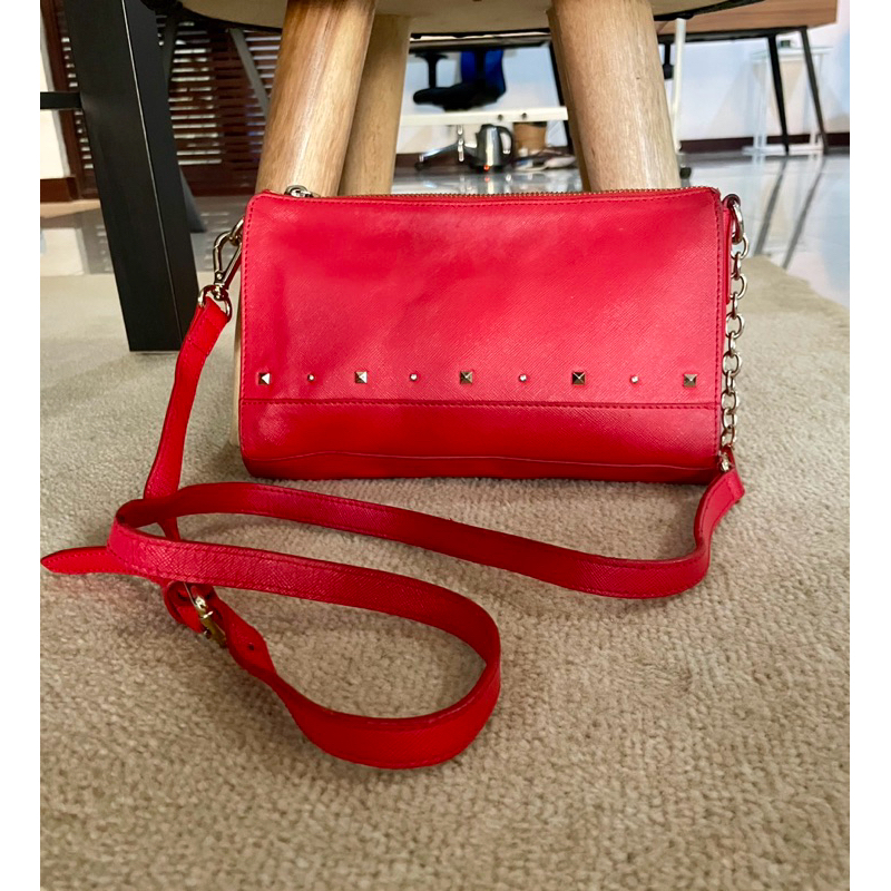 RhizLiza red studded sling bag