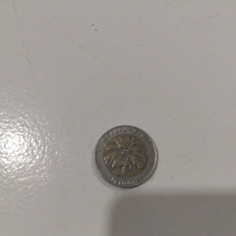 uang koin seribu rupiah kelapa sawit