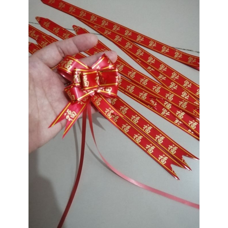 

Pita Serut Imlek size 18mm/ Pita Tarik isi 10pcs