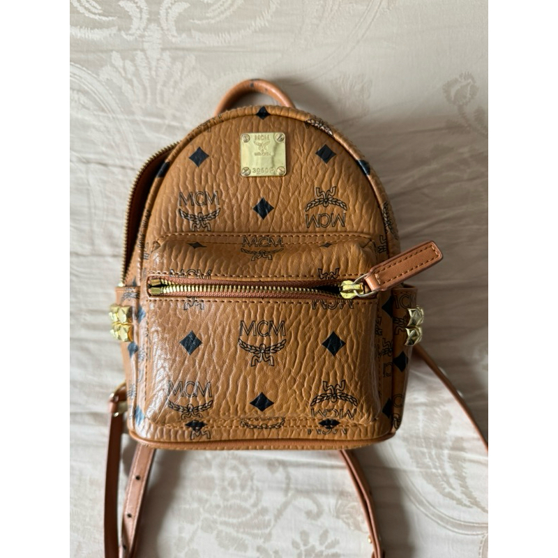 MCM STARK BEBE BOO SIDE STUDS BACKPACK IN VISETOS color-COGNAC size-X-MINI FAST SALE PRELOVED