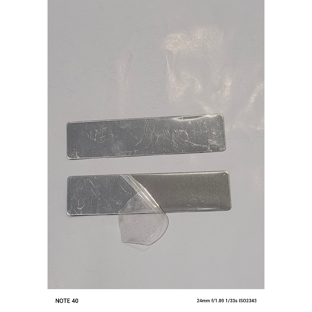 

NAMETAG BAHAN STAINLESS STEEL PLUS PROTECTOR