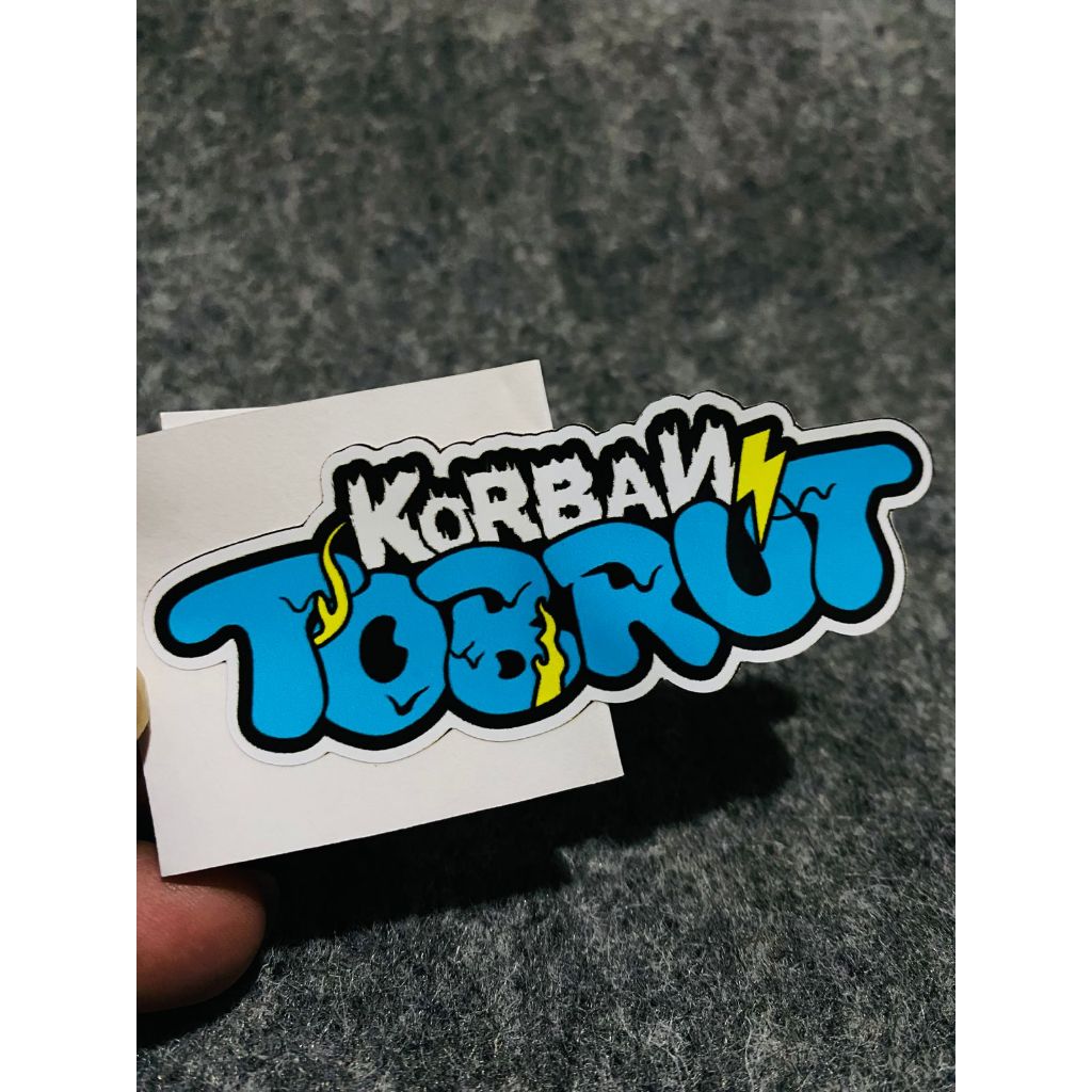 

Stiker Sticker Korban Tobrut 9cm x 4xm Bahan Vinyl Glossy dan Hologram Sudah di Potong Presisi