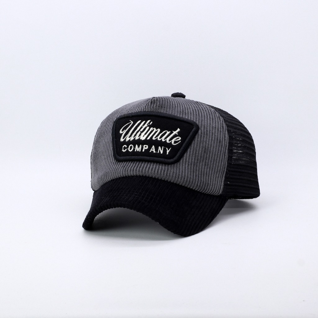 TOPI JARING TRUCKER LIDAH PENDEK BAHAN CORDUROY GREY MIX HITAM ULTI COPMANY