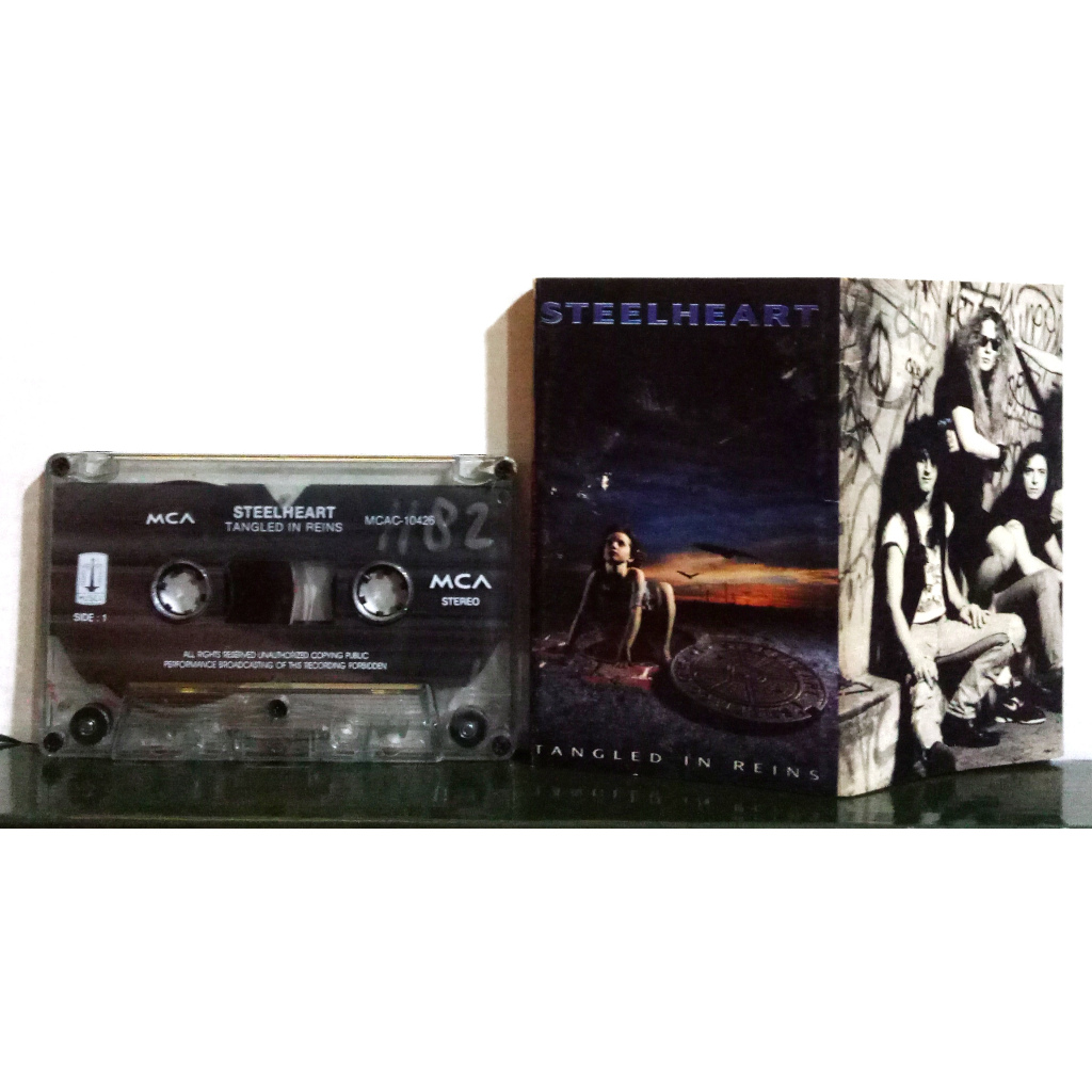 STEELHEART - TANGLED IN REINS - Kaset