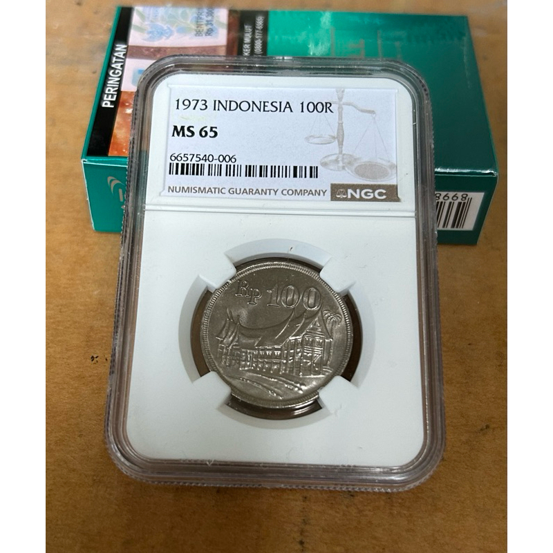 KOIN 100 RUPIAH 1973 TEBAL RUMAH GADANG SERTIFIKASI NGC MS 65