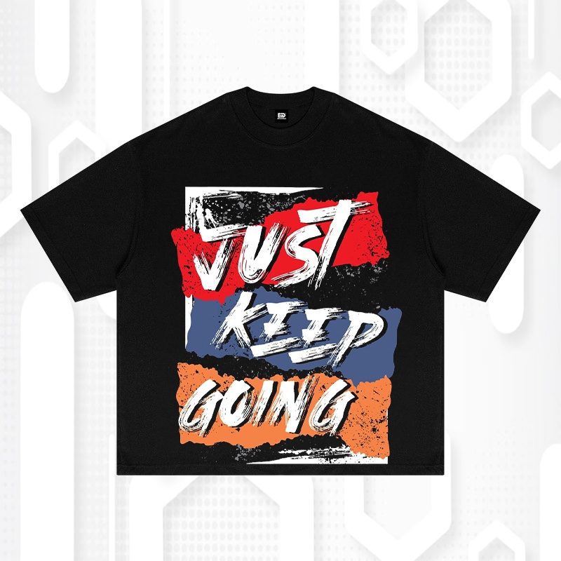 Kaos Distro Pria "JUST KEEP GOING" - Desain Graffiti Hitam dengan Teks Bold & Warna Block Urban Tren