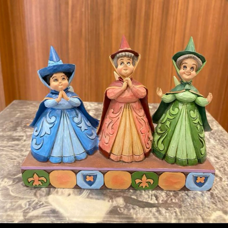Disney Traditions - Royal Guests Three Fairies features Flora, Fauna, and Merryweather from Sleeping