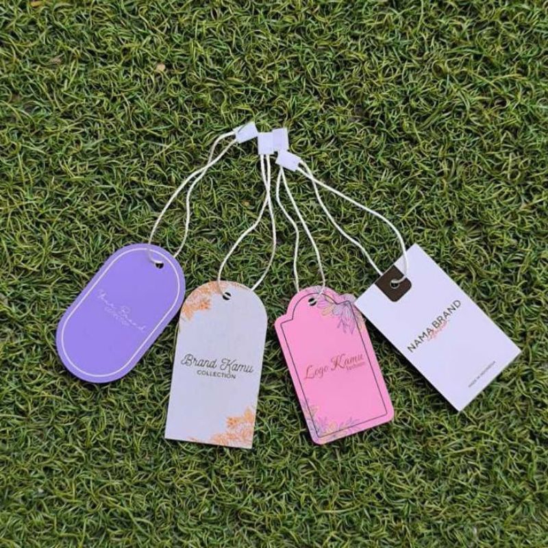 

HANGTAG TEBAL UV ART PAPER 310gsm gratis dsain cetak bulak balik costume. hangtag merk/label gantung