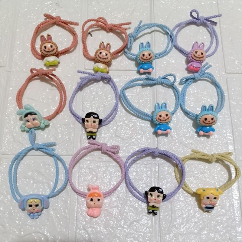 

Ikat rambut/kuncir rambut bandul karakter warna warni isi 12 pcs