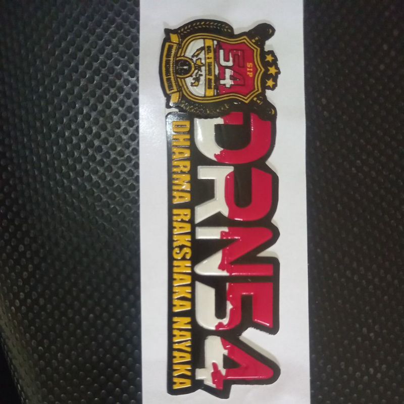 

stiker embos tulisan Dharma Rakshaka Nayaka