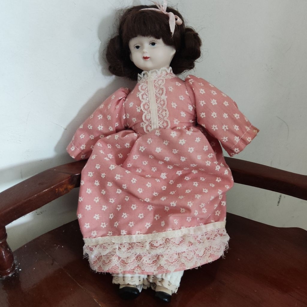 Antique Looking Face Porcelain Doll Wearing Pink Polkadots Dress and A Pink Ribbon. Boneka Porselen 
