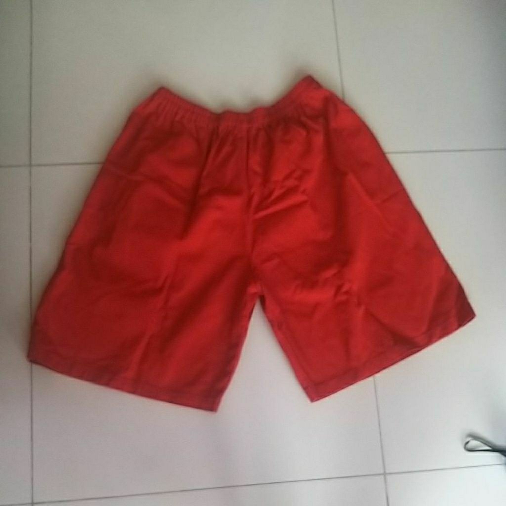 celana rok wanita setengah lutut, karet elastis, bahan lepis warna orange, bekas pakai dan masih lay