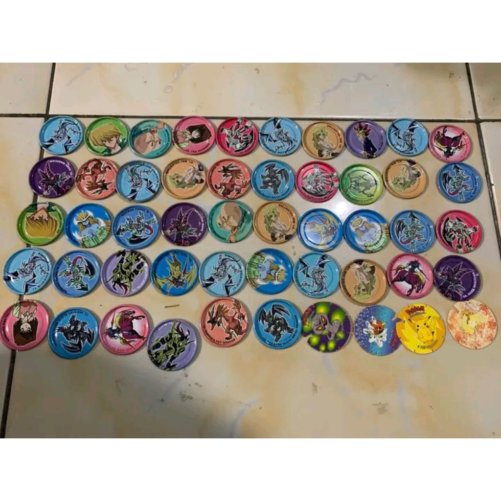 Tazos kaleng Yugi Oh bonus tazos plastik pokemon (kecuali pikachu)