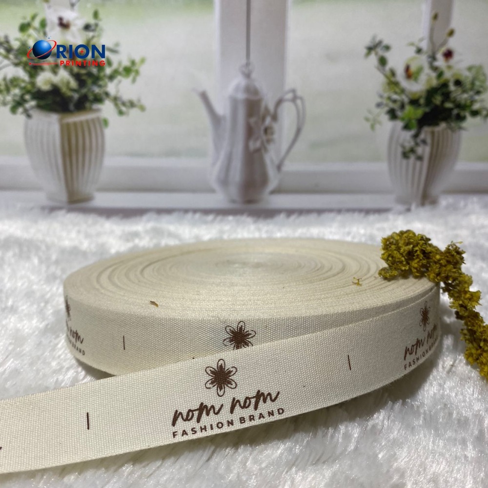 

Label Pita label baju premium termura Woven by Orion