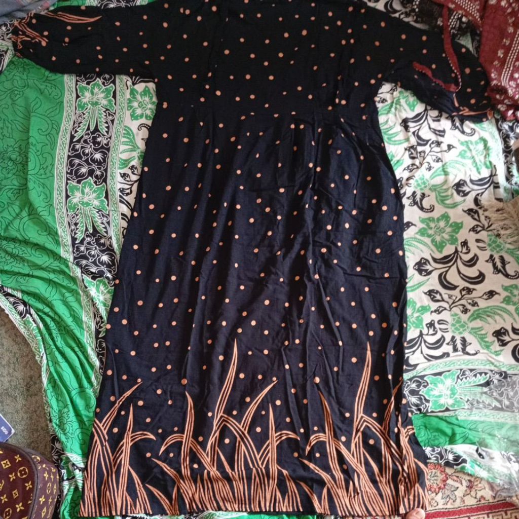 Daster rayon berwarna hitam motif polkadot oranye dan pola rumput di bagian bawah