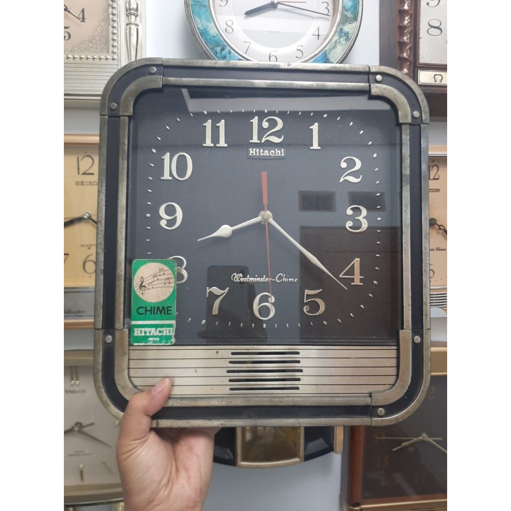 Jam dinding Melody Hitachi hitam