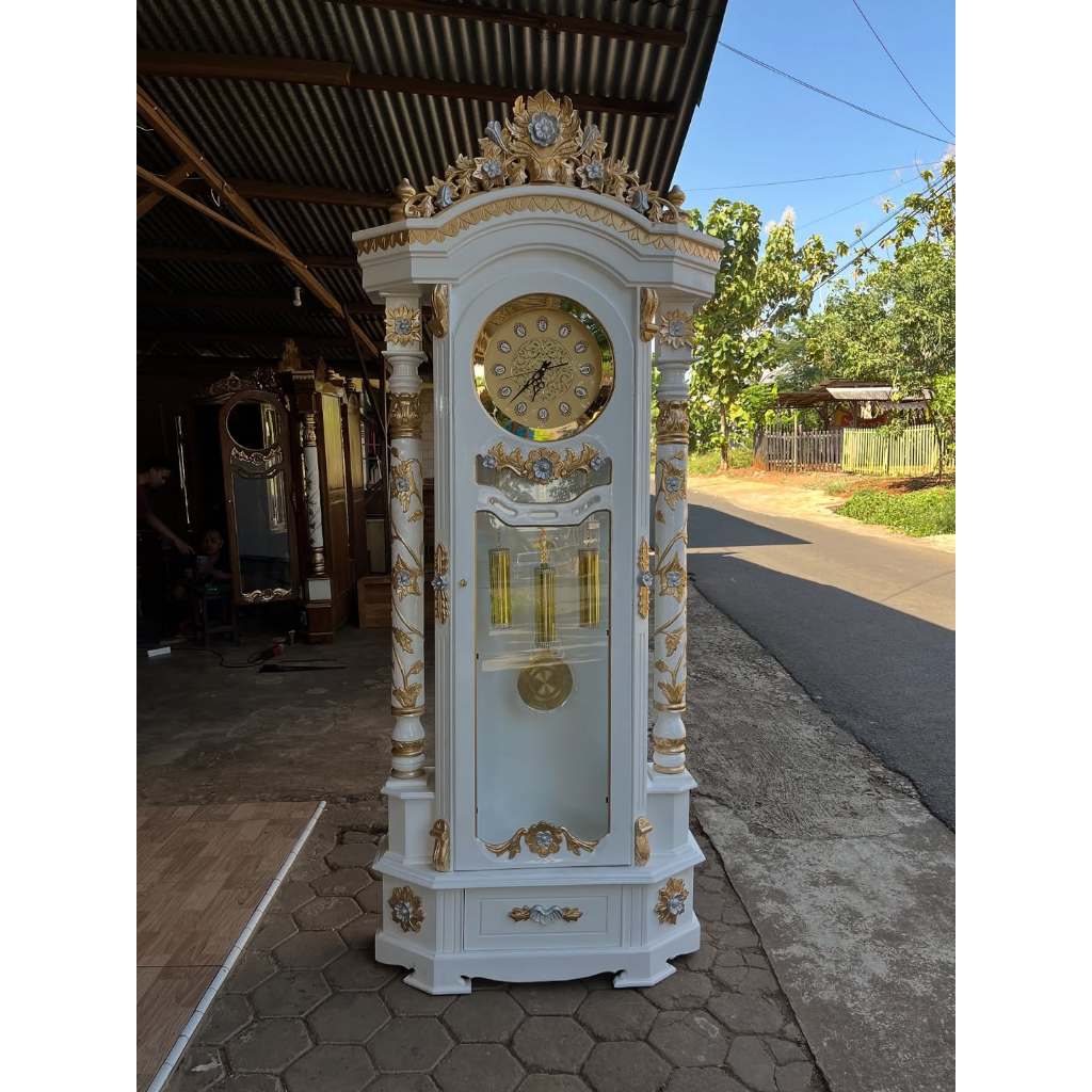 Almari Jam Rahwana Cat Duco Putih Kombinasi Emas Silver Kayu Jati