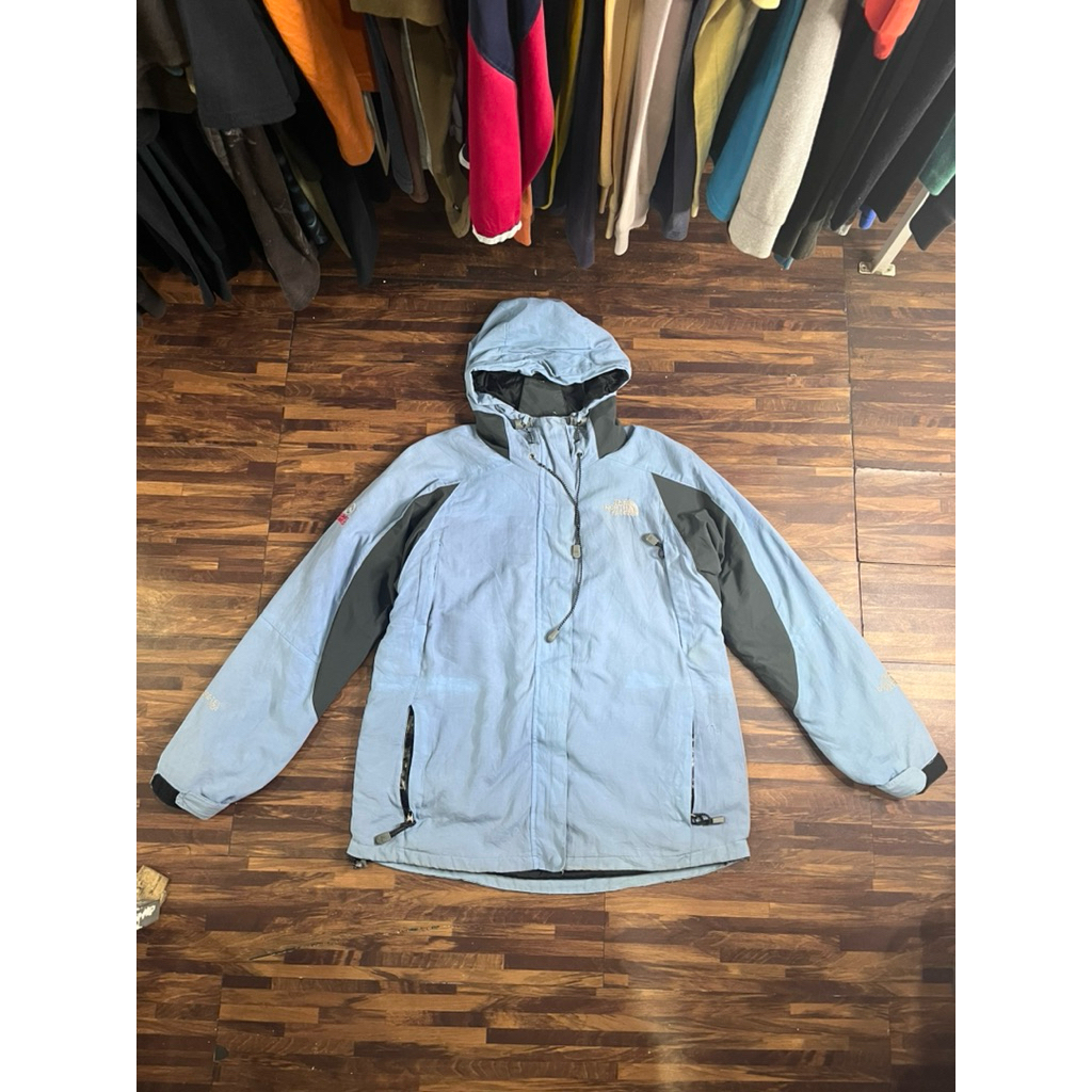 The North Face GORE-TEX jacket in light blue with a black fleece inner layer.