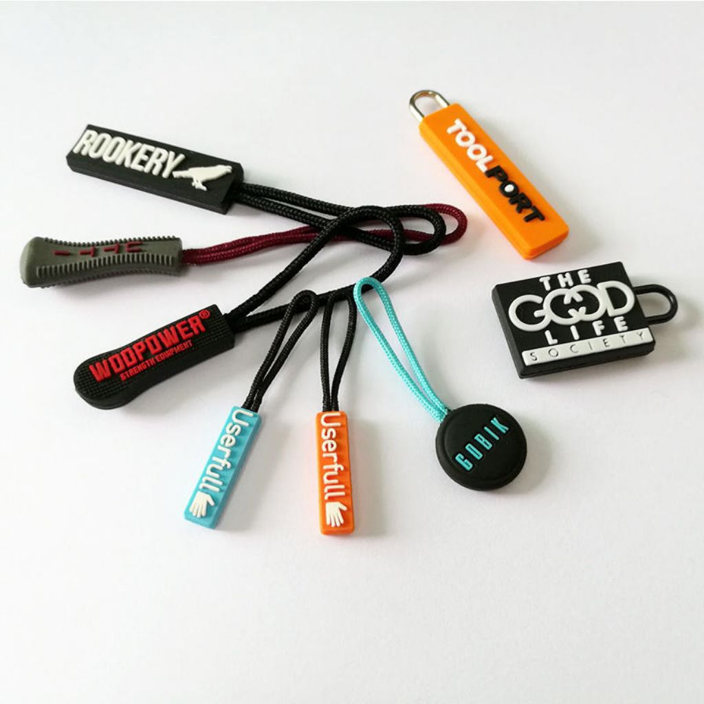 Zipper puller custom tarikan sleting resleting karet rubber 2d 4d dari tali besi murah dan termurah