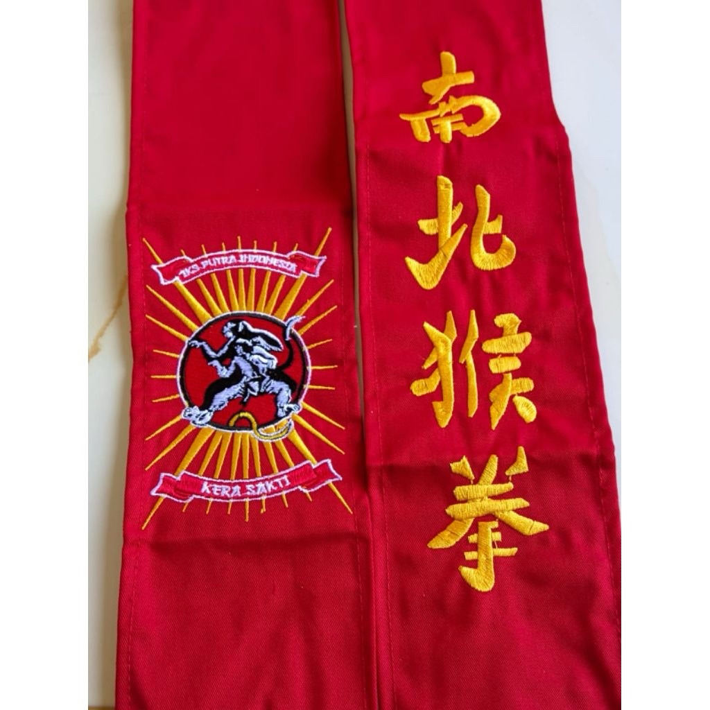 sabuk ikspi kera sakti merah bahan drill kain lembut bordir rapi komputer